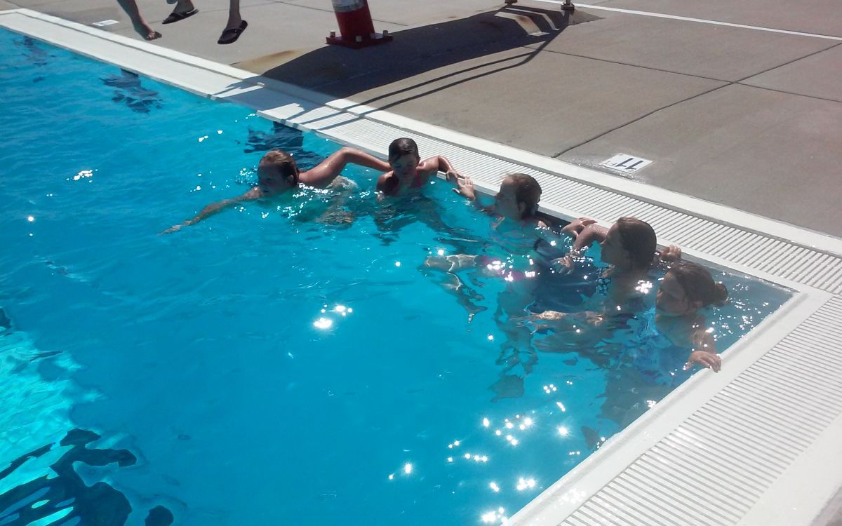 Image of 5 boys in deep end of pool